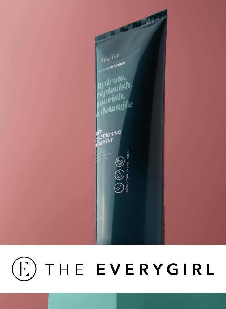 A tube of RevAir Extreme Hydration Deep Conditioning Treatment standing upright against a dusty rose background, with The Everygirl logo displayed below