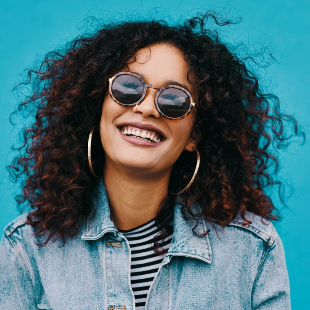 happy black woman with natural curly hair 