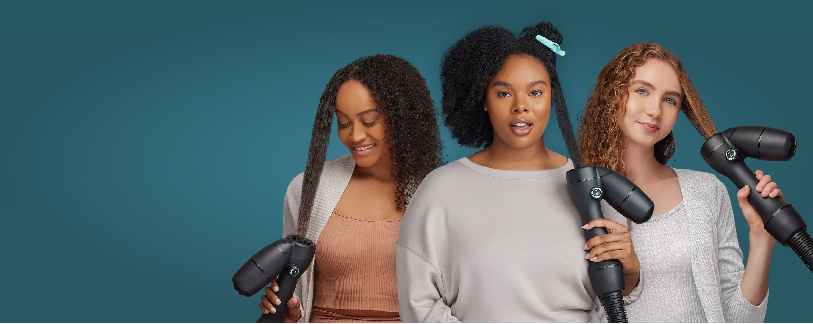 Group of three diverse women all using the RevAir Reverse-Air Dryer to dry and stretch their hair