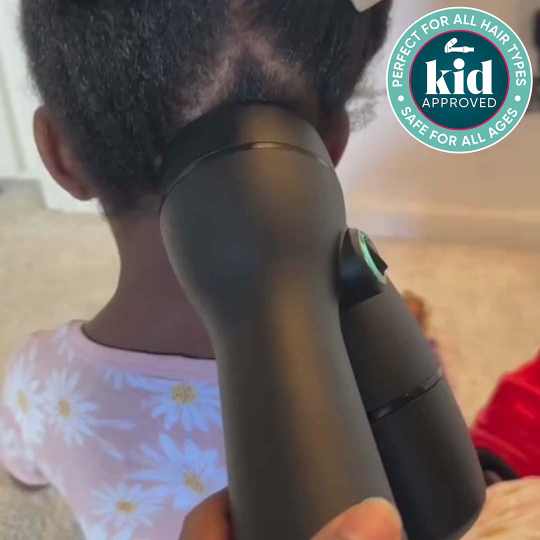 Load video: Mother using a RevAir to dry and stretch a young girl's hair while she plays with toys. Badge: Kid approved, perfect for all hair types, safe for all ages.